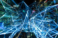 Dynamic urban scene showcasing interconnected light trails representing digital communication networks.